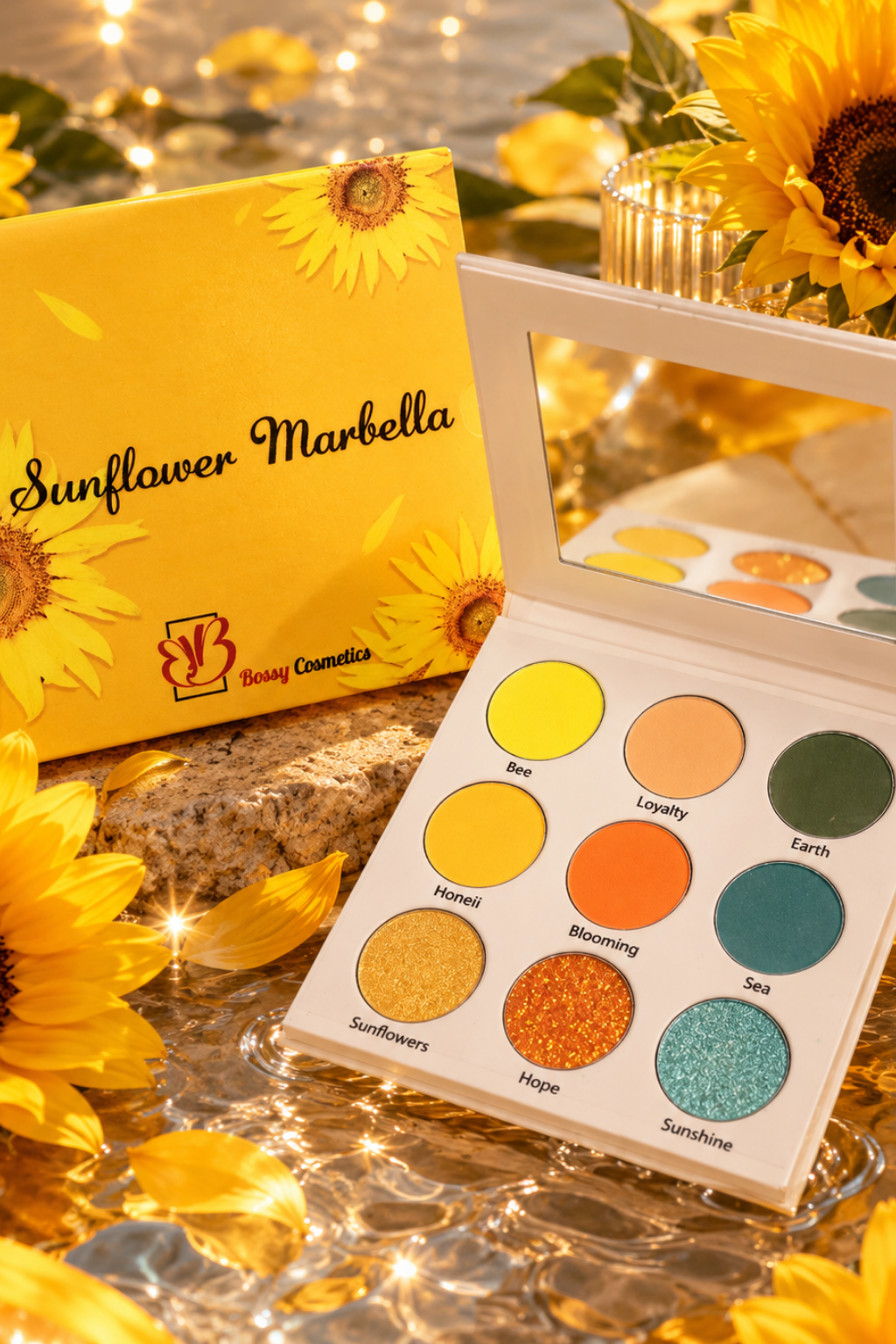 Open eyeshadow palette and its matching box labeled 'Sunflower Marbella' by Body Cosmetics, styled with sunflowers and warm decorative lights on a reflective surface.