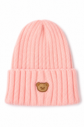 A light pink ribbed knit beanie hat with a folded cuff and a small embroidered brown bear face patch on the front, shown against a plain white background.