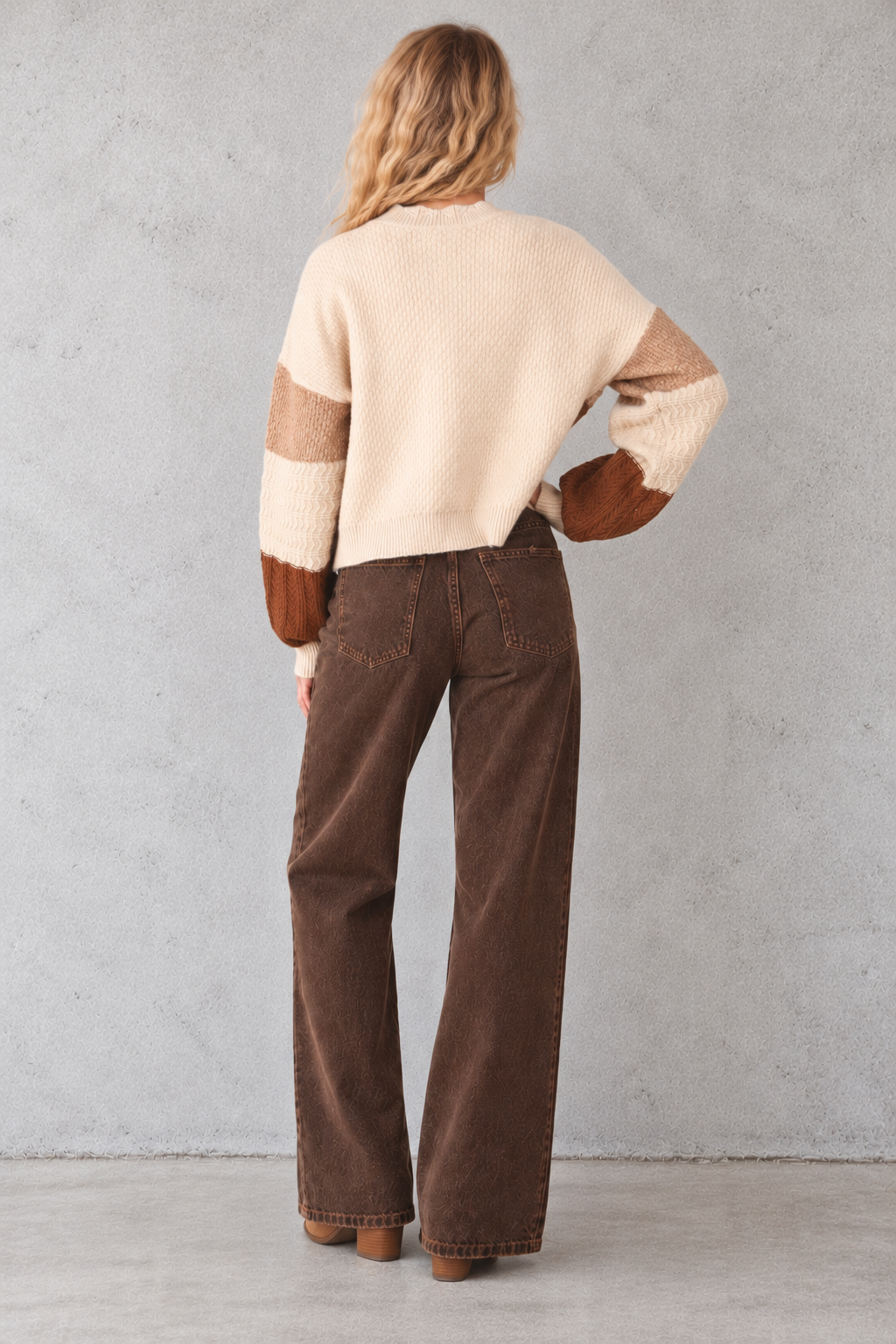 A women's knit cardigan sweater featuring a patchwork design with cream, brown, sage green, and tan blocks, complete with a scalloped neckline, button closure, and ribbed cuffs and hem.